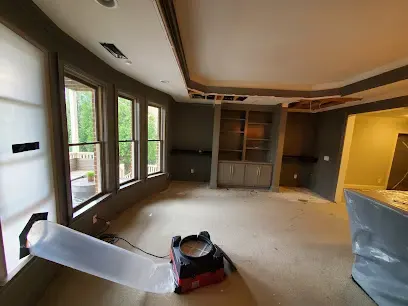 Air mover ducted into a wall cavity during structural drying in Duluth
